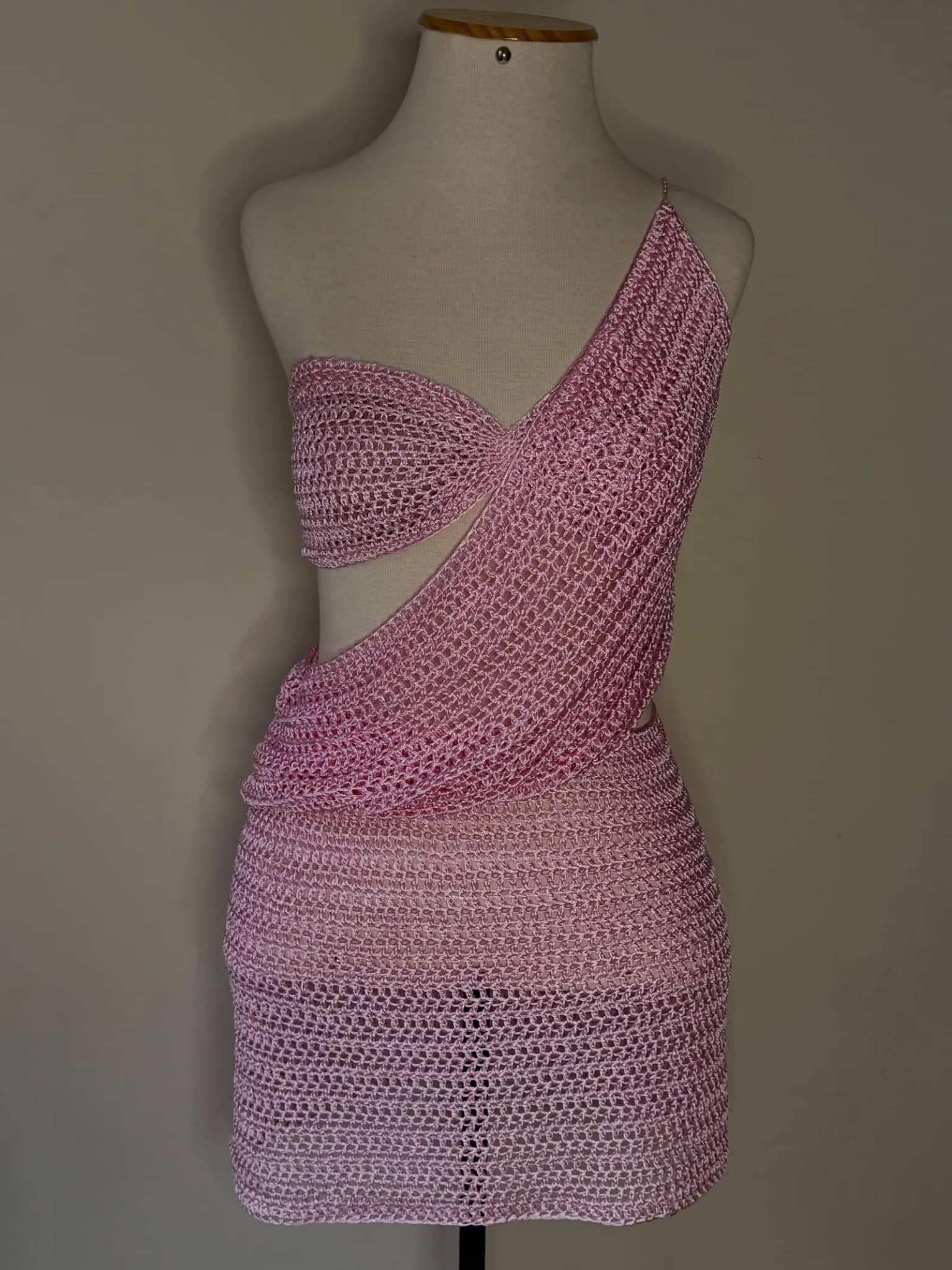 Conjunto de crochê rosa com faixa diagonal, no manequim